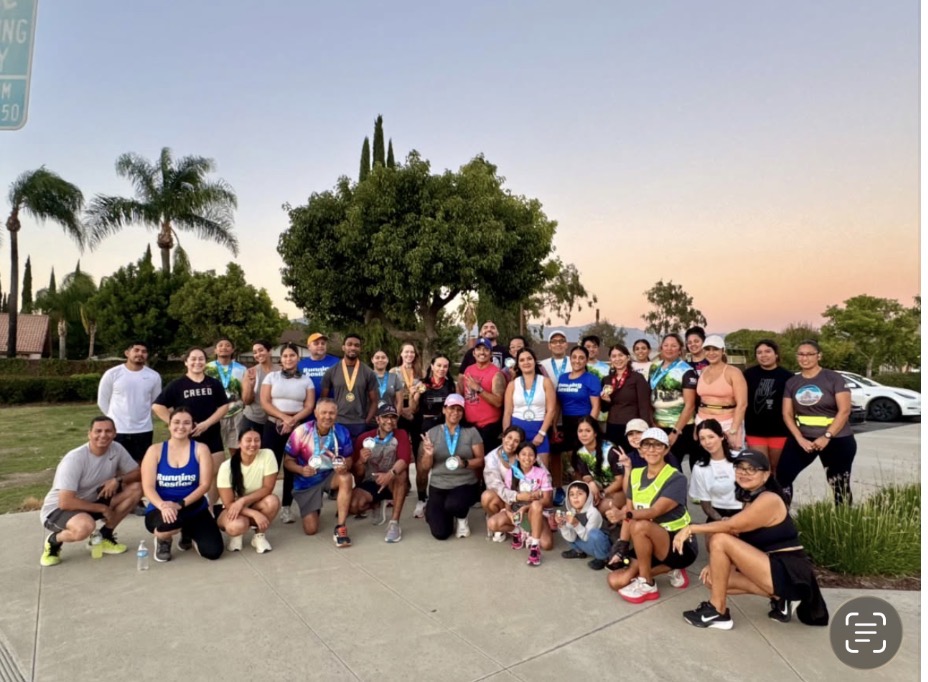 Running Besties community gathered outdoors for a group photo